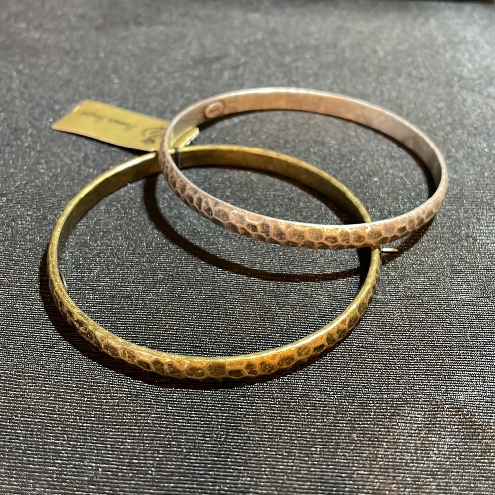 NWT a set of two hammered metal bangle bracelets, one antique brass one silver